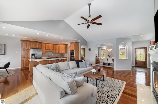 726 Doe Trl, Mount Pleasant, MI 48858 - living room featuring arched walkways, wood finished floors, a ceiling fan, baseboards, and recessed lighting