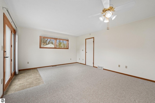 203 W Sixteenth St, Traverse City, MI 49684 - unfurnished room with a ceiling fan, light carpet, and baseboards