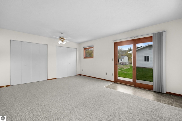 203 W Sixteenth St, Traverse City, MI 49684 - unfurnished living room featuring baseboards, a ceiling fan, and carpet floors