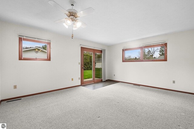 203 W Sixteenth St, Traverse City, MI 49684 - carpeted empty room with healthy amount of natural light, baseboards, and a ceiling fan