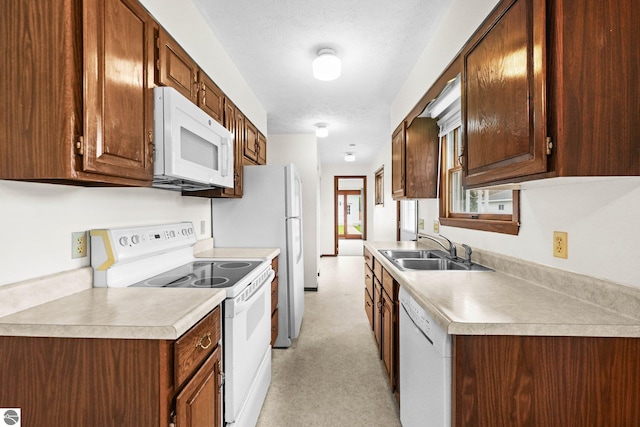 203 W Sixteenth St, Traverse City, MI 49684 - kitchen with white appliances, a sink, and light countertops