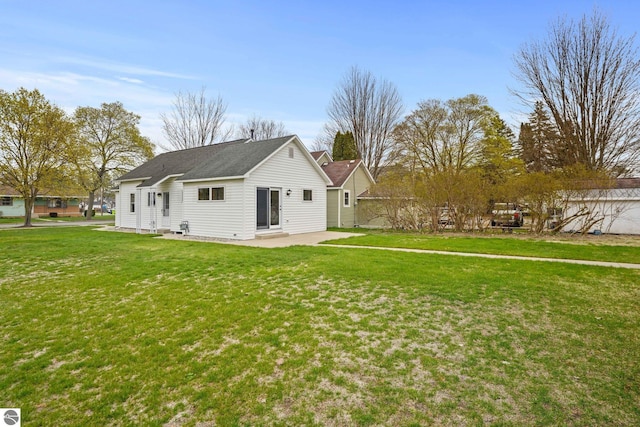 203 W Sixteenth St, Traverse City, MI 49684 - rear view of house with a patio and a lawn