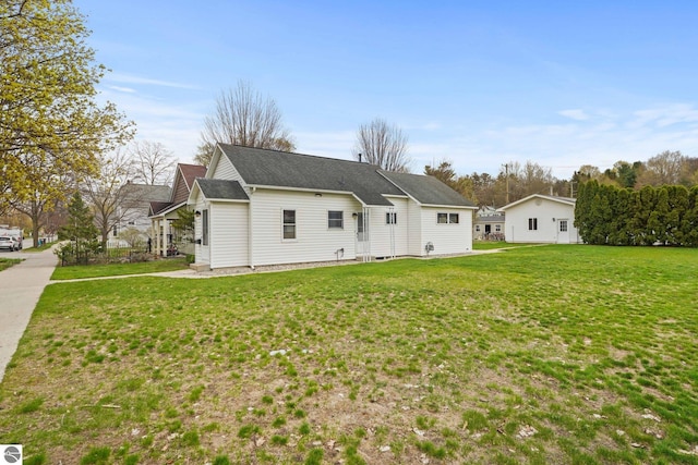 203 W Sixteenth St, Traverse City, MI 49684 - view of front of house featuring a front lawn and roof with shingles