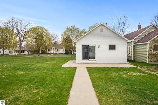 203 W Sixteenth St, Traverse City, MI 49684 - rear view of house featuring a lawn and a patio area
