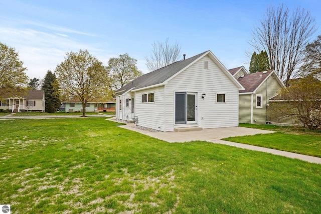 203 W Sixteenth St, Traverse City, MI 49684 - rear view of house featuring a patio area and a yard