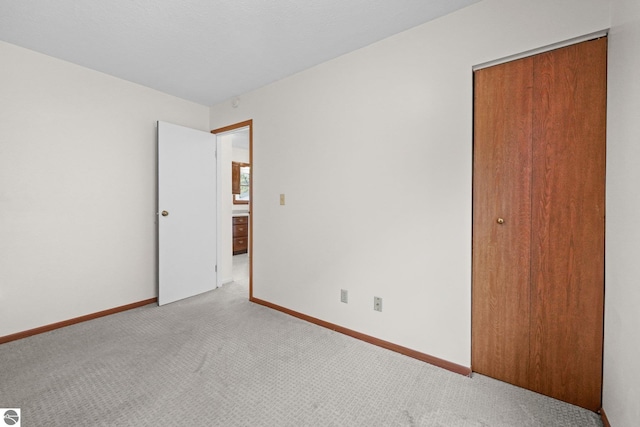 203 W Sixteenth St, Traverse City, MI 49684 - unfurnished bedroom with carpet, a closet, and baseboards