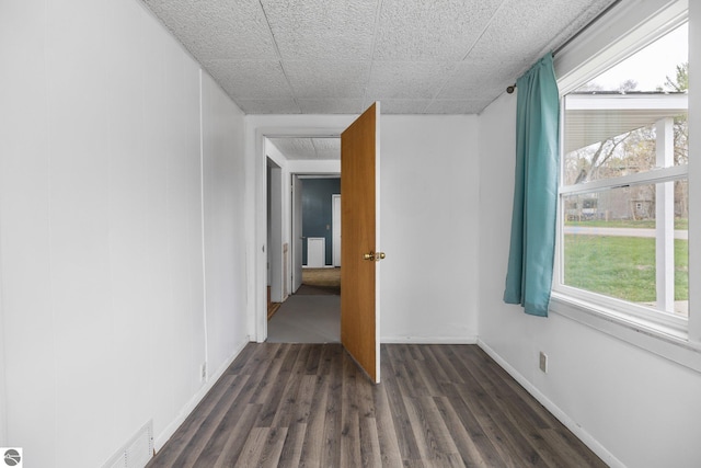 unfurnished room with dark wood finished floors