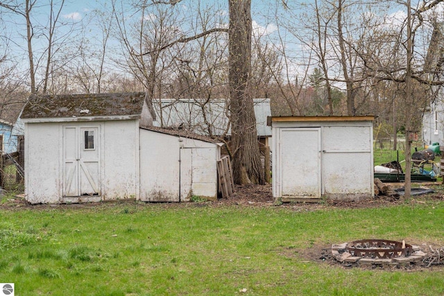 view of shed with an outdoor fire pit