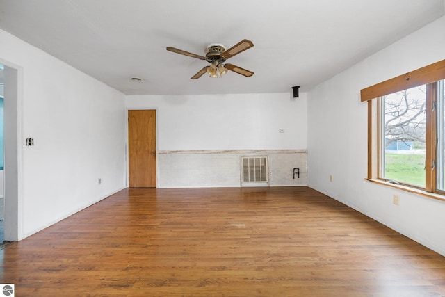 unfurnished living room featuring a ceiling fan and wood finished floors