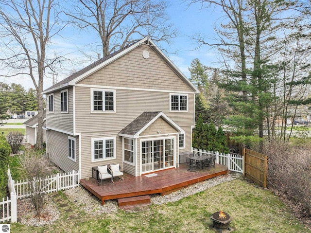 5945 E M-55, Cadillac, MI 49601 - back of house with a fire pit and a wooden deck