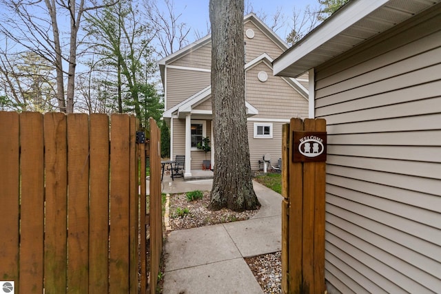 5945 E M-55, Cadillac, MI 49601 - view of side of property with a patio, fence, and a gate