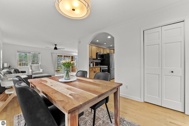 5945 E M-55, Cadillac, MI 49601 - dining space featuring light wood-style floors, ceiling fan, arched walkways, recessed lighting, and baseboards