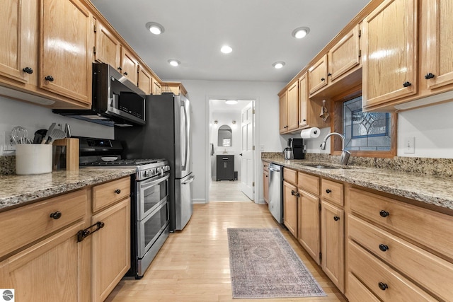 5945 E M-55, Cadillac, MI 49601 - kitchen with stainless steel appliances, a sink, light wood finished floors, light stone countertops, and recessed lighting