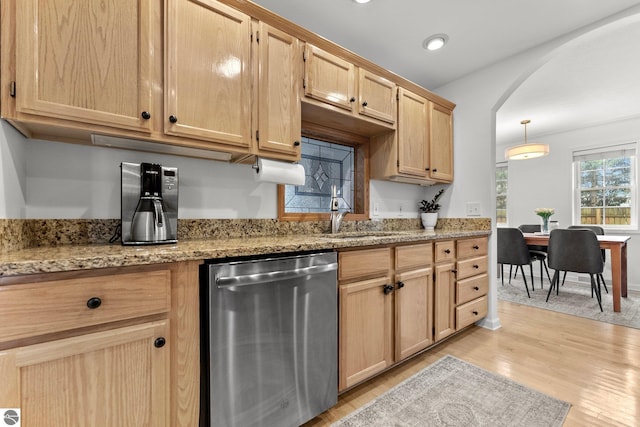 5945 E M-55, Cadillac, MI 49601 - kitchen with stainless steel dishwasher, a sink, light brown cabinetry, arched walkways, and light wood-style flooring