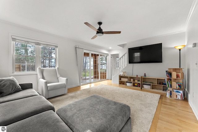 5945 E M-55, Cadillac, MI 49601 - living room with ornamental molding, stairs, ceiling fan, light wood-type flooring, and baseboards