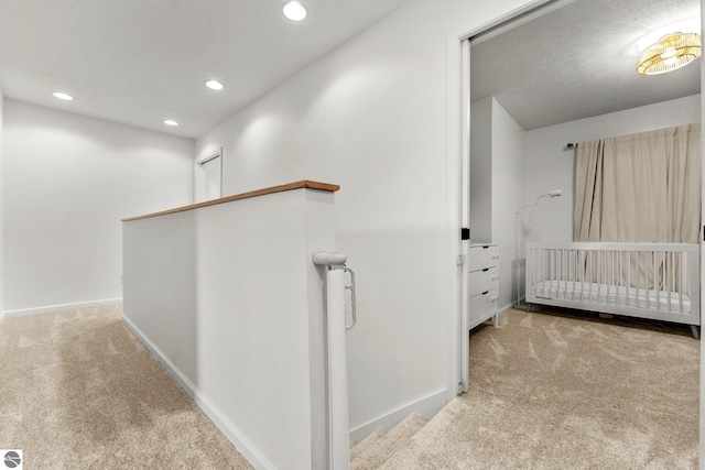 5945 E M-55, Cadillac, MI 49601 - hallway featuring carpet, an upstairs landing, recessed lighting, and baseboards