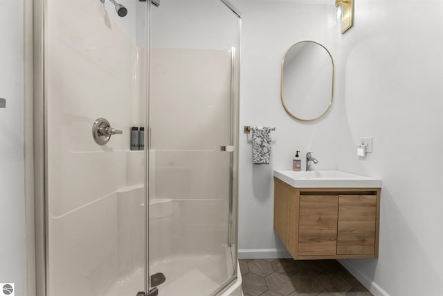 5945 E M-55, Cadillac, MI 49601 - bathroom with baseboards, a shower stall, tile patterned flooring, and vanity