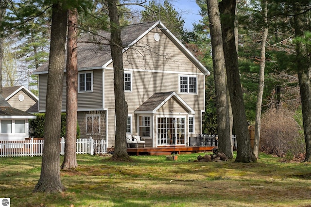 5945 E M-55, Cadillac, MI 49601 - back of property featuring a wooden deck and a shingled roof