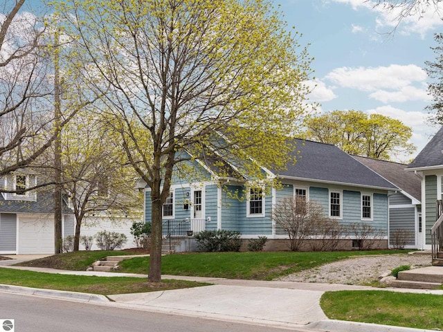 view of front of property featuring a garage and a front lawn