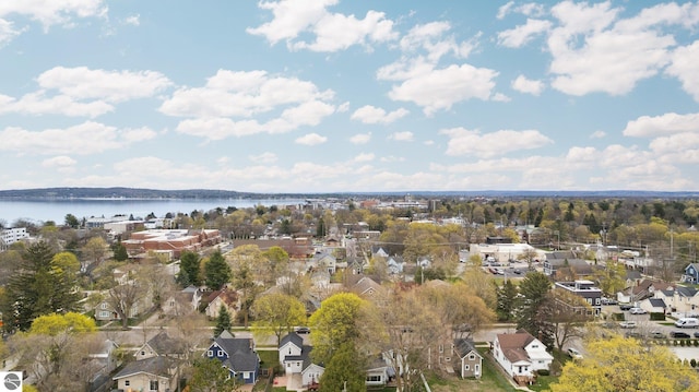 aerial view of property's location with a large body of water and nearby suburban area