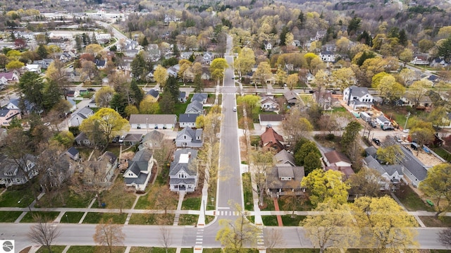 aerial view of property and surrounding area featuring nearby suburban area