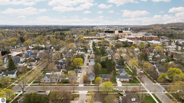 aerial view of property and surrounding area with nearby suburban area