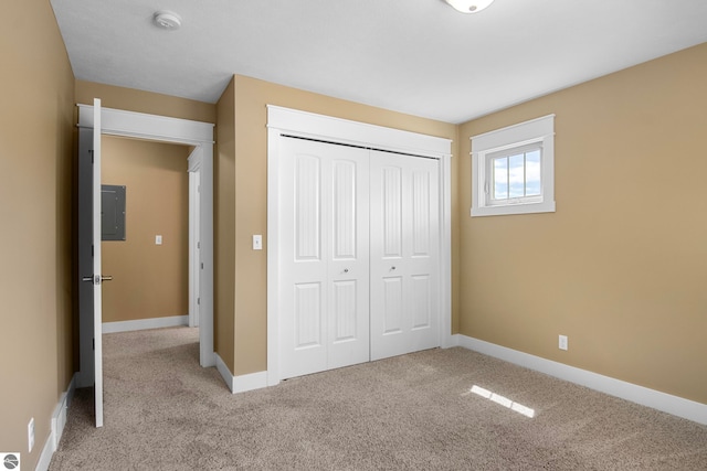 10889 Pine Bluff Dr Unit C, Traverse City, MI 49684 - unfurnished bedroom with carpet floors, a closet, electric panel, and baseboards