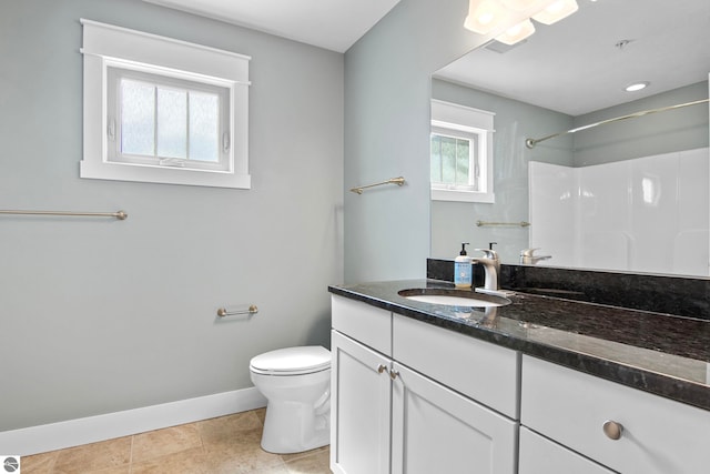 10889 Pine Bluff Dr Unit C, Traverse City, MI 49684 - bathroom featuring baseboards, toilet, vanity, a shower, and tile patterned flooring