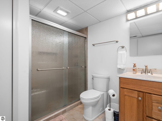 4381 Cherry Ln, Traverse City, MI 49684 - full bath featuring a drop ceiling, toilet, a shower stall, vanity, and tile patterned floors