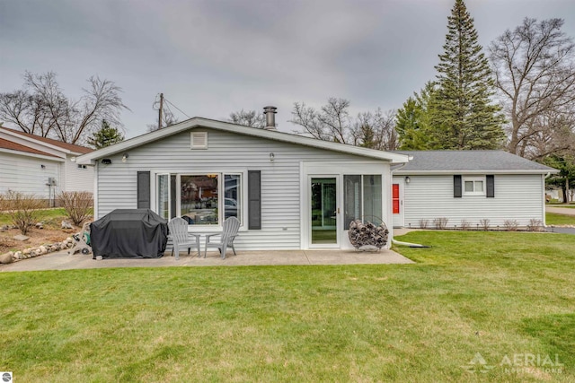 back of property with a patio area and a lawn