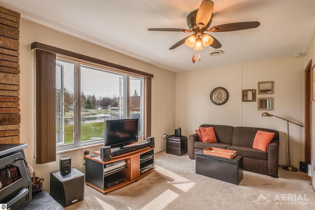 carpeted living area featuring ceiling fan