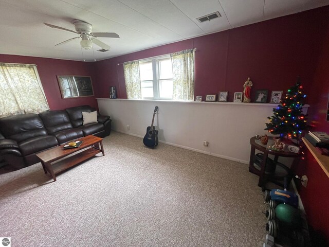 1993 W St, Central Lake, MI 49622 - living area with a ceiling fan, carpet flooring, and baseboards