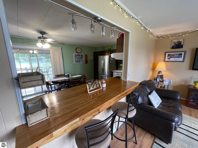 1993 W St, Central Lake, MI 49622 - dining room with track lighting, wood finished floors, and ceiling fan