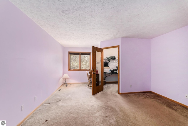 3691 Eastview Dr Unit 67, Traverse City, MI 49684 - carpeted empty room featuring a textured ceiling and baseboards