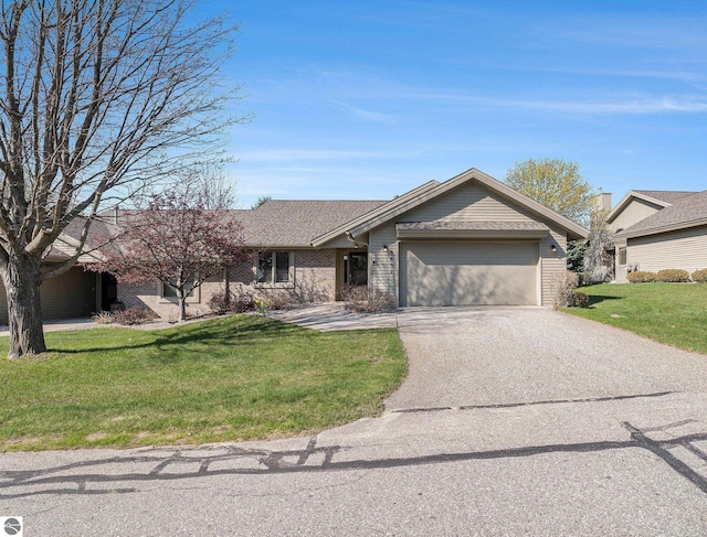 3691 Eastview Dr Unit 67, Traverse City, MI 49684 - ranch-style home featuring an attached garage, a front yard, driveway, and brick siding