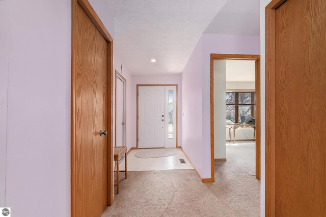 3691 Eastview Dr Unit 67, Traverse City, MI 49684 - hallway featuring light colored carpet and baseboards