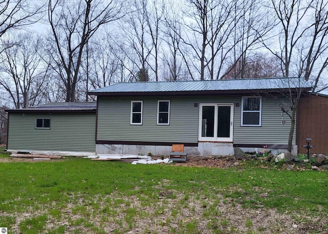 21187 Parkview Rd, Tustin, MI 49688 - rear view of house featuring a yard and metal roof