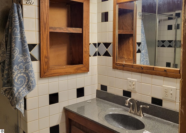21187 Parkview Rd, Tustin, MI 49688 - bathroom featuring vanity, tasteful backsplash, and a shower with door
