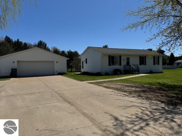 2195 S Sara Dr, Lake City, MI 49651 - single story home with an outdoor structure, a front yard, and a detached garage