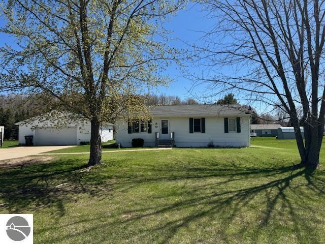 2195 S Sara Dr, Lake City, MI 49651 - ranch-style home with driveway, a front lawn, and an attached garage