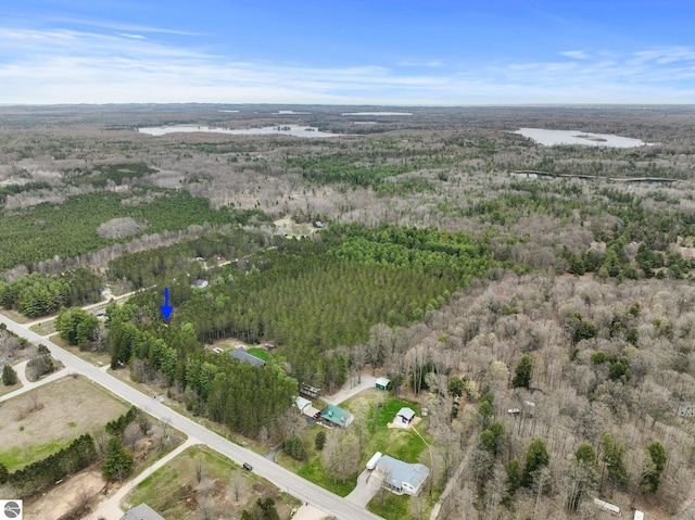 aerial view of property and surrounding area with a forest