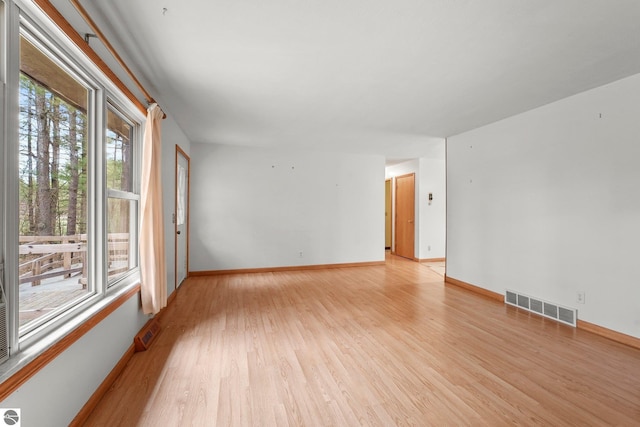 unfurnished room featuring light wood-type flooring and baseboards