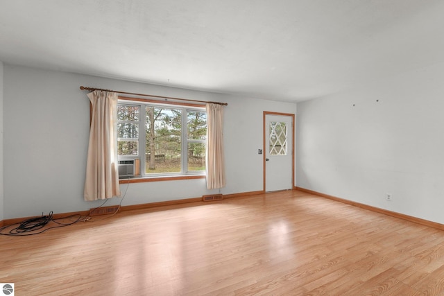 spare room with wood finished floors and baseboards