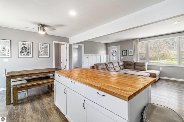 4507 Maidens Rd, Onekama, MI 49675 - kitchen with butcher block countertops, dark wood-type flooring, open floor plan, white cabinetry, and ceiling fan