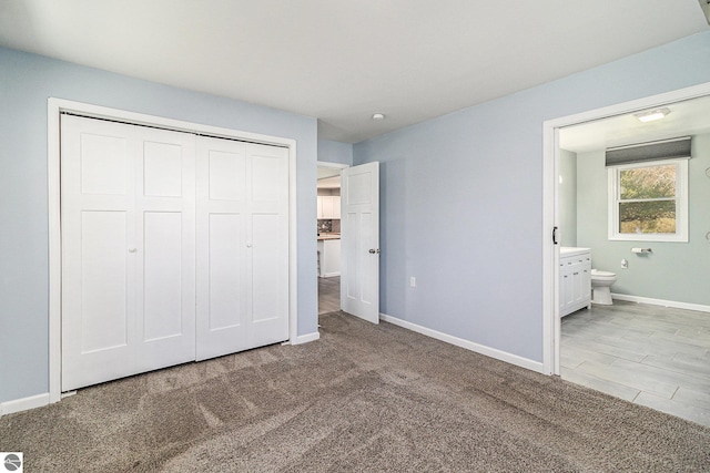 4507 Maidens Rd, Onekama, MI 49675 - unfurnished bedroom with a closet, baseboards, carpet, and ensuite bathroom