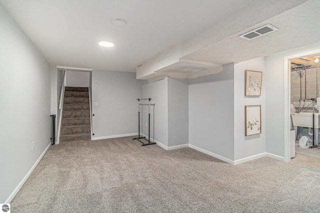 4507 Maidens Rd, Onekama, MI 49675 - finished basement featuring carpet floors, stairs, and baseboards