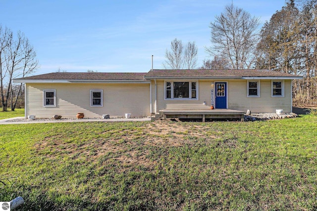 4507 Maidens Rd, Onekama, MI 49675 - rear view of property featuring a lawn and a deck