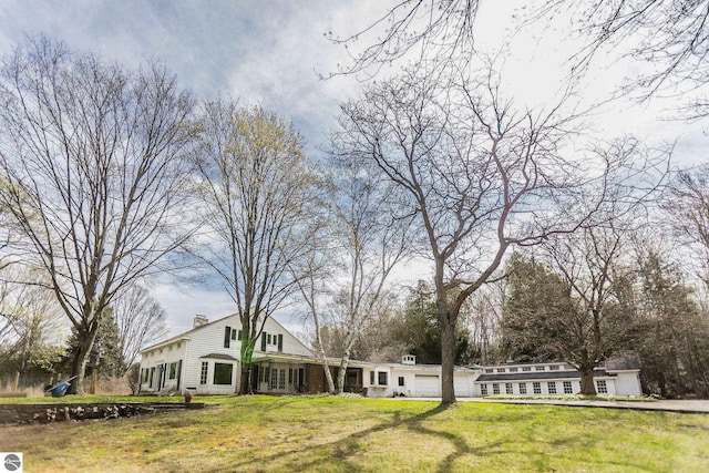 3080 N Lake Leelanau Dr, Lake Leelanau, MI 49653 - view of grassy yard with an attached garage