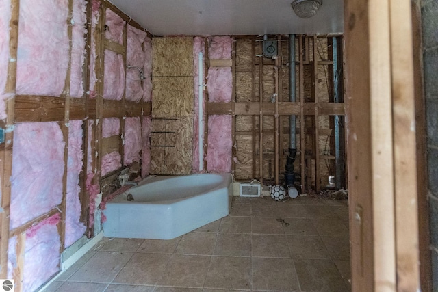 3080 N Lake Leelanau Dr, Lake Leelanau, MI 49653 - bathroom with tile patterned flooring and a tub to relax in