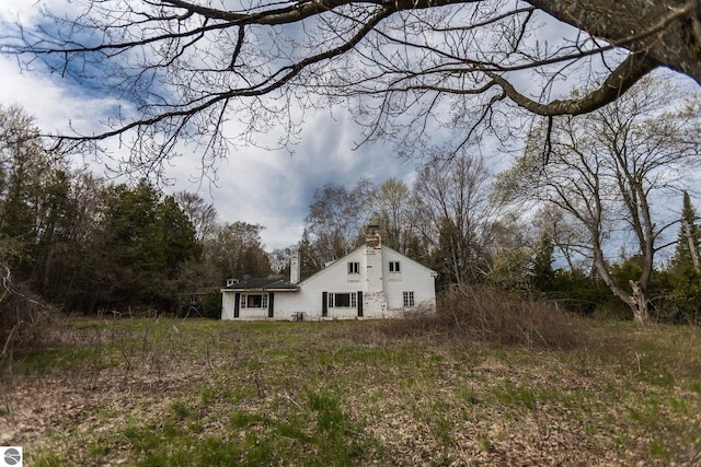 3080 N Lake Leelanau Dr, Lake Leelanau, MI 49653 - view of side of home with a chimney